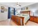 Comfortable bedroom featuring neutral carpet, blue decor, wooden furniture, and window views at 2609 Dinville St, Kissimmee, FL 34747