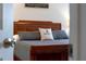 Bedroom featuring neutral carpet, grey bedding, wooden furniture, and bright sunlight at 2609 Dinville St, Kissimmee, FL 34747