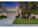 Charming two-story home featuring a well-manicured lawn and mature trees at 2609 Dinville St, Kissimmee, FL 34747