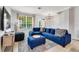The cozy living room features a blue sectional sofa and a large window that brings in natural light at 2609 Dinville St, Kissimmee, FL 34747