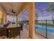 Outdoor patio featuring a dining area, ceiling fan, and screened-in pool view at 2609 Dinville St, Kissimmee, FL 34747