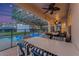 Outdoor patio featuring a dining area, ceiling fan, and screened-in pool view at 2609 Dinville St, Kissimmee, FL 34747