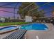 Sparkling pool and spa surrounded by a screened enclosure and lounge chairs at 2609 Dinville St, Kissimmee, FL 34747