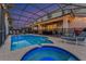 Private screen enclosed pool and patio area featuring lounge chairs, outdoor seating, and a serene twilight sky at 2609 Dinville St, Kissimmee, FL 34747