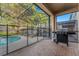 Relaxing screened-in pool area with lounge chairs and outdoor grill, perfect for entertaining at 2609 Dinville St, Kissimmee, FL 34747