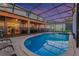 Screen enclosed pool and patio area featuring lounge chairs, outdoor seating, and a beautiful twilight sky at 2609 Dinville St, Kissimmee, FL 34747