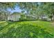Spacious backyard features lush green grass and a screened-in patio for relaxing and entertaining at 288 Englenook Dr, Debary, FL 32713