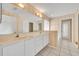 The bathroom features double sinks, a large mirror, white cabinets, and a walk-in shower at 288 Englenook Dr, Debary, FL 32713