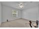 Bedroom with neutral carpet, ceiling fan, and a window at 288 Englenook Dr, Debary, FL 32713