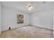 A simply decorated bedroom features carpet, a ceiling fan, and a window at 288 Englenook Dr, Debary, FL 32713