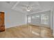 Bright bedroom featuring a tray ceiling, ceiling fan and light hardwood flooring at 288 Englenook Dr, Debary, FL 32713