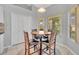 Casual dining area featuring a round wooden table, chairs, and natural light from surrounding windows at 288 Englenook Dr, Debary, FL 32713
