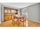Cozy dining room features a wooden table, chairs, and a large built-in cabinet with a window at 288 Englenook Dr, Debary, FL 32713