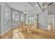 Bright dining room with hardwood floors, large windows, and a classic chandelier at 288 Englenook Dr, Debary, FL 32713