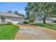 Long driveway leads to a two-car garage, with manicured landscaping and a lush green lawn at 288 Englenook Dr, Debary, FL 32713