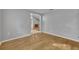 Empty room with hardwood floors, neutral paint, and open doorway to adjacent rooms at 288 Englenook Dr, Debary, FL 32713