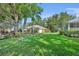 A charming single story home features a well manicured lawn and mature landscaping at 288 Englenook Dr, Debary, FL 32713