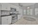 Modern kitchen featuring white cabinets, stainless steel appliances, and a breakfast nook at 288 Englenook Dr, Debary, FL 32713