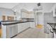 Bright kitchen features white cabinets, stainless steel appliances, and black granite countertops at 288 Englenook Dr, Debary, FL 32713