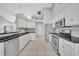 Bright kitchen features white cabinets, stainless steel appliances, and black granite countertops at 288 Englenook Dr, Debary, FL 32713