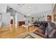 Spacious living room with vaulted ceilings, hardwood floors, and large leather sofa at 288 Englenook Dr, Debary, FL 32713