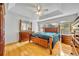 A spacious main bedroom showcases a tray ceiling, wood floors, and large windows overlooking the lake at 288 Englenook Dr, Debary, FL 32713