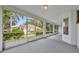 Enclosed patio featuring white railings and a view of the green backyard at 288 Englenook Dr, Debary, FL 32713