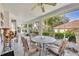 A lovely screened in porch overlooks the backyard and features a round glass table and ornate metal chairs at 288 Englenook Dr, Debary, FL 32713