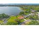 Expansive lakefront property featuring a private dock, lush lawn, and a home with a terracotta roof at 3108 Troy Dr, Orlando, FL 32806