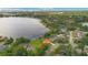 Stunning lakefront home with a private dock, manicured lawn, and charming terracotta roof at 3108 Troy Dr, Orlando, FL 32806