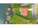 Overhead view of lakefront home with terracotta roof, dock, well-maintained lawn, and manicured landscaping at 3108 Troy Dr, Orlando, FL 32806