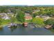 Beautiful lakefront property with manicured lawn, private dock, and a charming home with mature trees at 3108 Troy Dr, Orlando, FL 32806