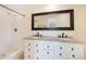 Bathroom vanity with dual sinks and granite countertop adjacent to a tiled shower at 3108 Troy Dr, Orlando, FL 32806