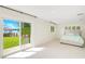 Bedroom with a waterfront view, sliding glass doors to the backyard, and neutral decor at 3108 Troy Dr, Orlando, FL 32806