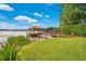 Tranquil waterfront view featuring a private dock and gazebo, mature landscaping, and serene lake waters at 3108 Troy Dr, Orlando, FL 32806