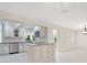 Bright kitchen features stainless appliances, white cabinetry, island, and decorative tile backsplash at 3108 Troy Dr, Orlando, FL 32806