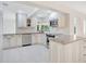 Elegant kitchen featuring white cabinets, stainless steel appliances, and granite countertops, designed for both style and practicality at 3108 Troy Dr, Orlando, FL 32806
