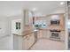 Beautiful kitchen with white cabinetry, stainless steel appliances, and granite counters, enhanced by a view of the waterfront at 3108 Troy Dr, Orlando, FL 32806