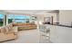 Open living area featuring an expansive waterfront view and bar seating by the kitchen at 3108 Troy Dr, Orlando, FL 32806