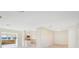 Bright, open-concept living space with tile floors, seamlessly connecting the kitchen, living room, and serene water views at 3108 Troy Dr, Orlando, FL 32806