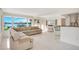 Bright living room with beautiful water view, large beige couch, and white tile flooring at 3108 Troy Dr, Orlando, FL 32806