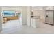 Stylish living area with easy flow to the kitchen, featuring sleek tile flooring and picturesque views of the waterfront at 3108 Troy Dr, Orlando, FL 32806