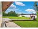 Expansive backyard featuring waterfront access, a private dock and gazebo, and lush lawn with mature trees at 3108 Troy Dr, Orlando, FL 32806