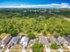 An aerial view of the neighborhood shows lush trees and neighboring homes at 3120 Ginger Cir, Orlando, FL 32826