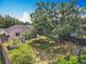 A spacious, fenced backyard features a large shade tree and storage shed at 3120 Ginger Cir, Orlando, FL 32826