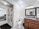 Bathroom featuring a stylish vanity with granite countertop, modern fixtures, and a shower with a geometric-patterned curtain at 3120 Ginger Cir, Orlando, FL 32826