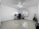 Spacious bedroom with tile flooring, ceiling fan, and a window offering natural light, ideal as a home office space at 3120 Ginger Cir, Orlando, FL 32826