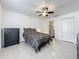 Bedroom showcasing modern tile flooring, ceiling fan, and a walk-in closet, offering a simple, uncluttered design at 3120 Ginger Cir, Orlando, FL 32826