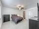 Bedroom featuring modern tile flooring, ceiling fan, and closet, offering simple and uncluttered design at 3120 Ginger Cir, Orlando, FL 32826