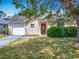 Charming single-story home with well-maintained lawn, front shrubs, and a one car garage at 3120 Ginger Cir, Orlando, FL 32826